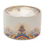 Decorative ceramic ashtray with colorful patterned rim on white background