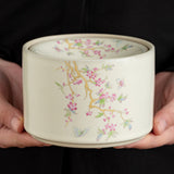 Wisteria-pattern ceramic ashtray held in hand