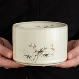 Bamboo-design ceramic ashtray held in hand