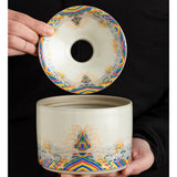 Hand holding decorative ceramic ashtray with removable funnel lid