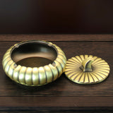 Covered metal ashtray with lid open showing deep bowl for cigarettes