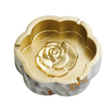 Gold-tone interior flower shaped ceramic ashtray with raised rose center