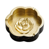 Black gold marble flower shaped ashtray with gold-tone interior and cigarette rests
