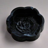 Black smoke flower shaped ceramic ashtray with glossy dark marble-style finish