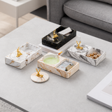 Ceramic ashtrays with lids and storage compartments displayed on coffee table