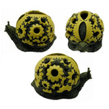 Yellow snail ashtray top and side views with decorative shell pattern and open bowl