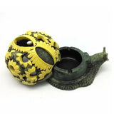 Yellow snail-style ashtray with open shell design and black cigarette holder bowl