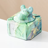 Mint gold covered ceramic ashtray with sculpted ram head knob and marble-style finish
