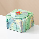 Mint gold covered ceramic ashtray with red enamel knob and cigarette rest grooves