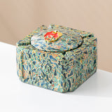 Ocean swirl covered ceramic ashtray with red enamel decorative knob and raised side relief