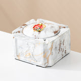 White gold covered ceramic ashtray with red enamel decorative knob and gold marble accents