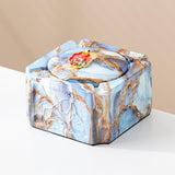 Blue gold covered ceramic ashtray with red enamel knob and raised animal relief detail