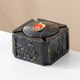 Black gold covered ceramic ashtray with red enamel knob and gold marble-style veining