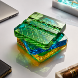 Stacked diamond-cut crystal glass cigar rests in Amber Gold, Sapphire Blue, Emerald Green and Aqua Clear
