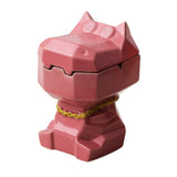 Pink dizzy hippo ceramic ashtray with lid and gold tone necklace on white background
