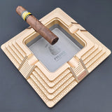 Antique gold Egyptian pyramid cigar ashtray with cigar resting on built-in cigar rests