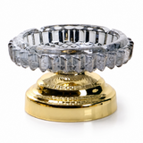 Smoke gray faceted glass ashtray with metal stand on white background