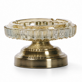 Antique bronze faceted glass ashtray with metal stand on white background