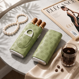 Sage green cigar cases displayed with pearls magazine and coffee