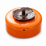 Persimmon ceramic ashtray with removable lid on white background
