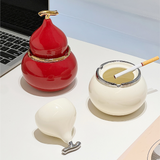 Red and white gourd-shaped ceramic ashtrays with glossy finish and gold-tone trim