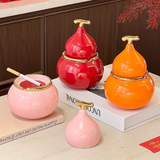 Pink red and orange gourd-shaped ceramic ashtrays with glossy finish and decorative tabletop style