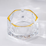 Clear silver iceberg glass ashtray with gold rim and thick faceted glass body