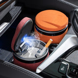 Orange LED car ashtray open in a car console with illuminated interior