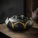 Closed black teal lotus flower ashtray with lid on a table