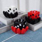 Lucky dice ceramic ashtray color variants displayed on books
