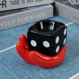 Black dice ceramic ashtray in red hand holder side view
