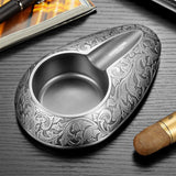Close-up of gunmetal silver engraved cigar ashtray detail