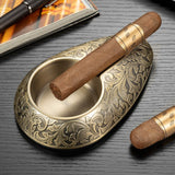 Antique gold engraved cigar ashtray with single cigar rest