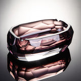Amethyst rose faceted crystal glass ashtray on reflective surface