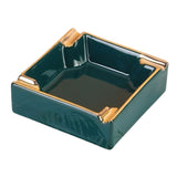 Emerald green ceramic ashtray with gold accents and 4 grooves to rest cigarettes