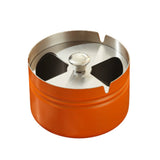 Short orange covered stainless steel ashtray with brushed metal lid and modern cylinder body