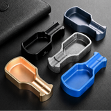 Modern metal cigar ashtrays in multiple color variants displayed together on dark background