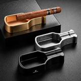 Metal cigar ashtray color variants on dark background, including gold, black, silver, and gunmetal finishes