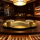 Polished gold stainless steel cigar ashtray displayed in a luxury cigar lounge