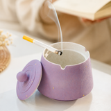 Lavender purple ceramic ashtray in use with cigarette and removable lid