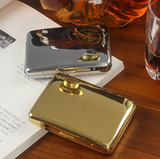 Gold metal cigarette case with cigarette shown in elegant tabletop lifestyle photo