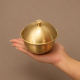 Solid brass covered ashtray held in hand showing compact size