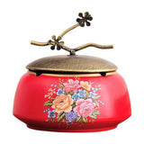 Vintage red ceramic ashtray with lid and floral bouquet design