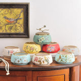 Set of vintage ceramic ashtrays with floral and bird designs in multiple colors