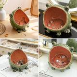 Frog-shaped jewelry holder with jewelry inside on a table.