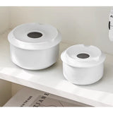 Small and large white ceramic ashtrays side by side on white background