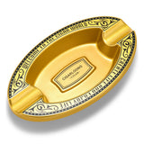 Gold oval resin cigar ashtray isolated on white background