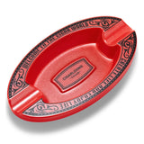Red oval resin cigar ashtray isolated on white background