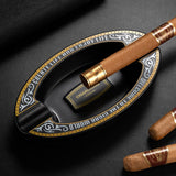 Top view of black oval resin cigar ashtray with cigar rests