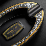 Close-up of black resin cigar ashtray with decorative center detail